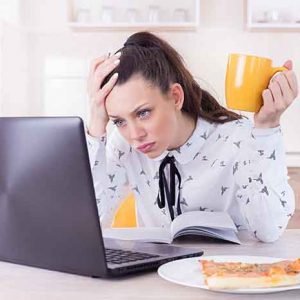 Tired woman working on laptop at home Tired woman working on laptop at home